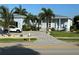 Light blue single-Gathering home with palm trees and a paved driveway at 3845 Bal Harbor Blvd, Punta Gorda, FL 33950