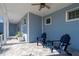 Peaceful porch with blue Adirondack chairs and a tiled floor at 3845 Bal Harbor Blvd, Punta Gorda, FL 33950