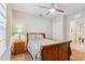 Bedroom with a wooden sleigh bed, nightstand, and ceiling fan at 3861 Cobblestone Ln, Port Charlotte, FL 33980