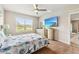 Main bedroom with large TV, dresser, and access to another room at 3861 Cobblestone Ln, Port Charlotte, FL 33980