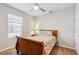 Cozy bedroom featuring a wooden sleigh bed and window blinds at 3861 Cobblestone Ln, Port Charlotte, FL 33980