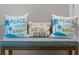 Teal bench with three decorative beach-themed pillows at 3861 Cobblestone Ln, Port Charlotte, FL 33980