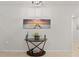 Entryway showcasing a glass-top console table and coastal artwork at 3861 Cobblestone Ln, Port Charlotte, FL 33980