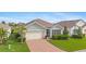 Single-story home with a brick driveway and palm trees at 3861 Cobblestone Ln, Port Charlotte, FL 33980