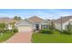 Single-story home with a brick driveway, landscaping, and two-car garage at 3861 Cobblestone Ln, Port Charlotte, FL 33980