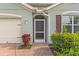 Dark brown front door with a screen door and brick walkway at 3861 Cobblestone Ln, Port Charlotte, FL 33980