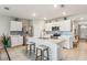 Modern kitchen with white cabinets, island, and stainless steel appliances at 3861 Cobblestone Ln, Port Charlotte, FL 33980