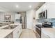 Modern kitchen with white cabinets, island, and stainless steel appliances at 3861 Cobblestone Ln, Port Charlotte, FL 33980