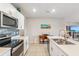 Modern kitchen with white cabinets, island, and stainless steel appliances at 3861 Cobblestone Ln, Port Charlotte, FL 33980