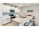 Modern kitchen with white cabinets, island, and stainless steel appliances at 3861 Cobblestone Ln, Port Charlotte, FL 33980