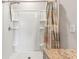 Clean shower with built in shelves and a shower curtain at 3861 Cobblestone Ln, Port Charlotte, FL 33980