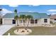 Single-story home with a green metal roof and landscaped yard at 500 Belvedere Ct, Punta Gorda, FL 33950