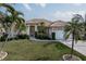 Single-story home with tile roof, landscaping, and two-car garage at 5430 Almar Dr, Punta Gorda, FL 33950