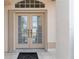 Double front doors with sidelights and a welcoming entryway at 5430 Almar Dr, Punta Gorda, FL 33950