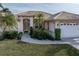 Front view of charming home with lush landscaping and welcoming entry at 5430 Almar Dr, Punta Gorda, FL 33950