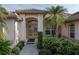 Front entry of the house with double doors and landscaping at 5430 Almar Dr, Punta Gorda, FL 33950