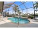 Inviting kidney-shaped pool with screened enclosure overlooking the canal at 5430 Almar Dr, Punta Gorda, FL 33950