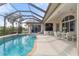 Inviting pool area with screened enclosure, perfect for relaxation and entertainment at 5430 Almar Dr, Punta Gorda, FL 33950