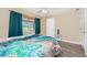 Inviting bedroom with light walls, wood-look flooring, and bright window at 5991 Gillot Blvd, Port Charlotte, FL 33981