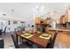 Open dining area with wood table, seating for four, adjacent to the kitchen and living room at 5991 Gillot Blvd, Port Charlotte, FL 33981