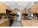 Well-equipped kitchen featuring wood cabinets, stainless steel appliances, and tile countertops at 5991 Gillot Blvd, Port Charlotte, FL 33981