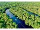 Aerial view of a tranquil waterway winding through lush greenery at 6208 Keating Ave, North Port, FL 34291