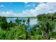 Scenic waterfront view with lush tropical vegetation at 6208 Keating Ave, North Port, FL 34291