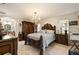 Main bedroom with dark wood furniture and a large chandelier at 674 Monaco Dr, Punta Gorda, FL 33950