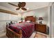 Cozy bedroom with red plaid bedding and ceiling fan at 674 Monaco Dr, Punta Gorda, FL 33950