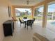 Covered patio with seating area, glass table, and view of canal at 721 Brenda Ct, Punta Gorda, FL 33950