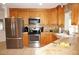 Kitchen with stainless steel appliances and light wood cabinets at 721 Brenda Ct, Punta Gorda, FL 33950