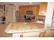 Kitchen features a breakfast bar with tile countertop at 721 Brenda Ct, Punta Gorda, FL 33950