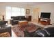 Living room with leather sofas, a large window, and an area rug at 721 Brenda Ct, Punta Gorda, FL 33950