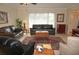 Living room with leather sofas, a large window, and an area rug at 721 Brenda Ct, Punta Gorda, FL 33950