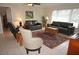 Living room with leather sofas, a large window, and an area rug at 721 Brenda Ct, Punta Gorda, FL 33950