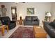 Living room with leather sofas, a large window, and an area rug at 721 Brenda Ct, Punta Gorda, FL 33950