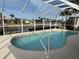 Relaxing kidney-shaped pool with screened enclosure at 721 Brenda Ct, Punta Gorda, FL 33950