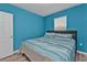 Bedroom with a queen-size bed and blue walls at 7249 W Lenox Cir, Punta Gorda, FL 33950