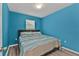 Bedroom with a queen-size bed and blue walls at 7249 W Lenox Cir, Punta Gorda, FL 33950