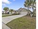 Single-story home with attached garage and landscaped lawn, located in a residential neighborhood at 7249 W Lenox Cir, Punta Gorda, FL 33950