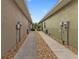 Neat walkway between two houses with gravel landscaping at 7249 W Lenox Cir, Punta Gorda, FL 33950