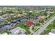 Aerial view showcasing a waterfront home with red tile roof and lush landscaping at 820 Bal Harbor Blvd, Punta Gorda, FL 33950