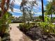 Brick walkway leading through lush tropical landscaping at 93 Vivante Blvd # 9325, Punta Gorda, FL 33950