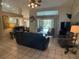 Spacious living room with a view of the pool, comfortable seating and large TV at 25332 Vantage Ln, Punta Gorda, FL 33983