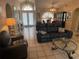 Living room with leather furniture, a large window, and access to the dining area at 25332 Vantage Ln, Punta Gorda, FL 33983