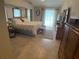 Bright main bedroom featuring a king bed and ensuite bathroom access at 25332 Vantage Ln, Punta Gorda, FL 33983