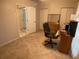 Home office with a desk and chair, adjacent to a bathroom at 25332 Vantage Ln, Punta Gorda, FL 33983