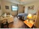 Comfortable bedroom with a queen-size bed and sitting area at 1022 Campbell St, Port Charlotte, FL 33953