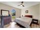 Spacious bedroom with king-size bed, large window, and wood-look floors at 1041 Harbour Park Ct, Punta Gorda, FL 33983