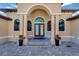 Elegant entryway with arched columns and double doors at 1041 Harbour Park Ct, Punta Gorda, FL 33983